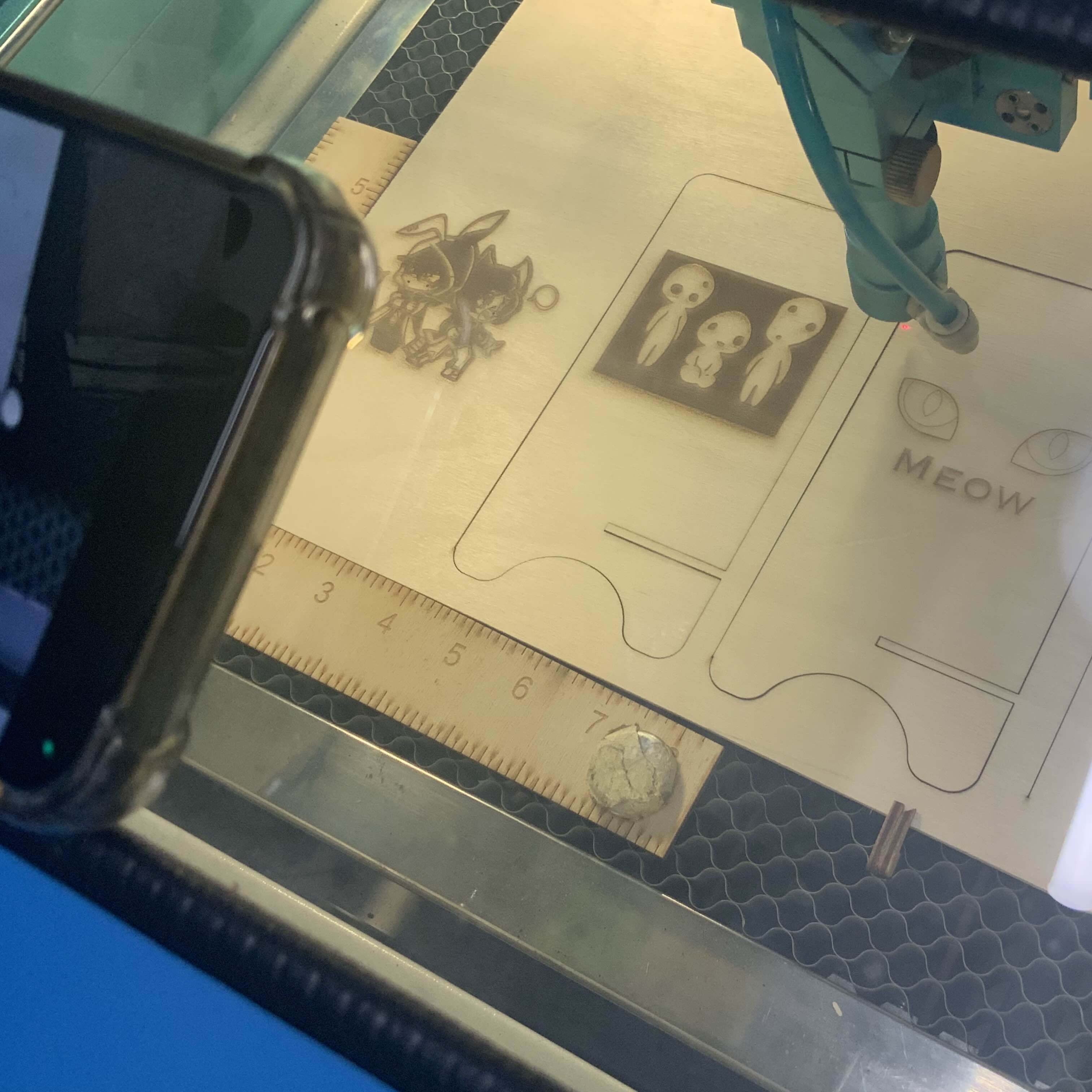 view of my phone recording the laser cutter while its working